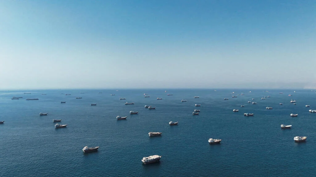 Hormuz Drone Clash Triggers USD Spike; Smoke Clouds Putin’s Economic Forum; EV Tariff Crisis Looms in Europe