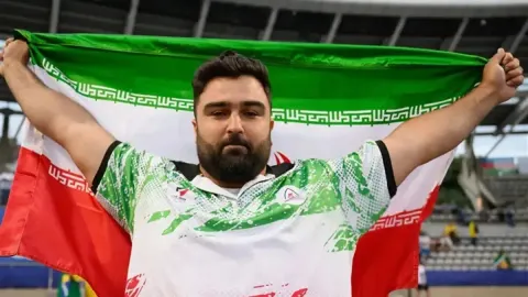 Khosravi Strikes Gold in Nagoya as Toman Slips and Unrest Grips French Cities